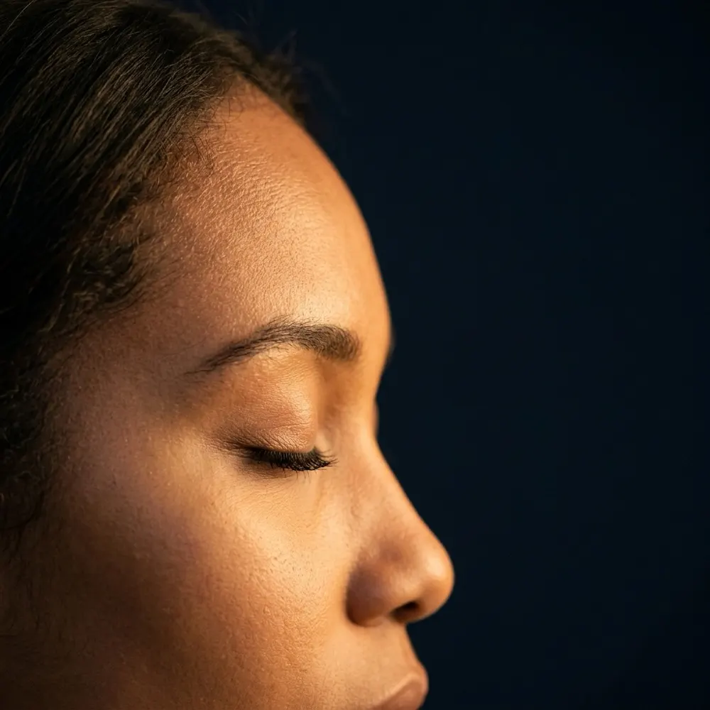 A woman with closed eyes, settled and still